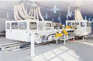 Advanced automated machinery with extraction ducts in a modern facility for flooring production.