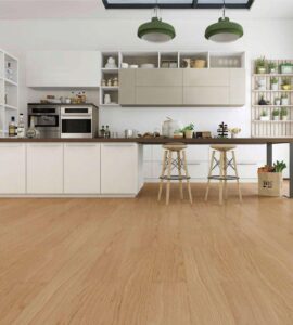 Modern kitchen with light wooden flooring, white cabinets, open shelves, green pendant lights, and a breakfast bar with stools.