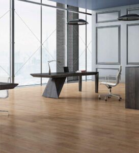 Executive office with floor-to-ceiling windows, light wooden flooring, a modern dark desk, and a sleek white office chair.