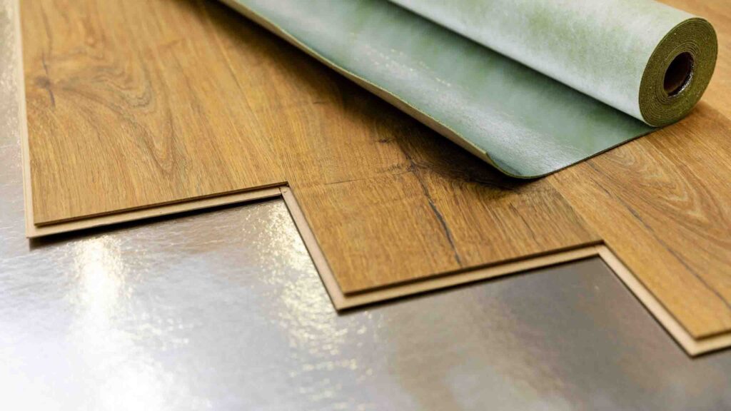SPC vinyl flooring with green underlayment on shiny subfloor