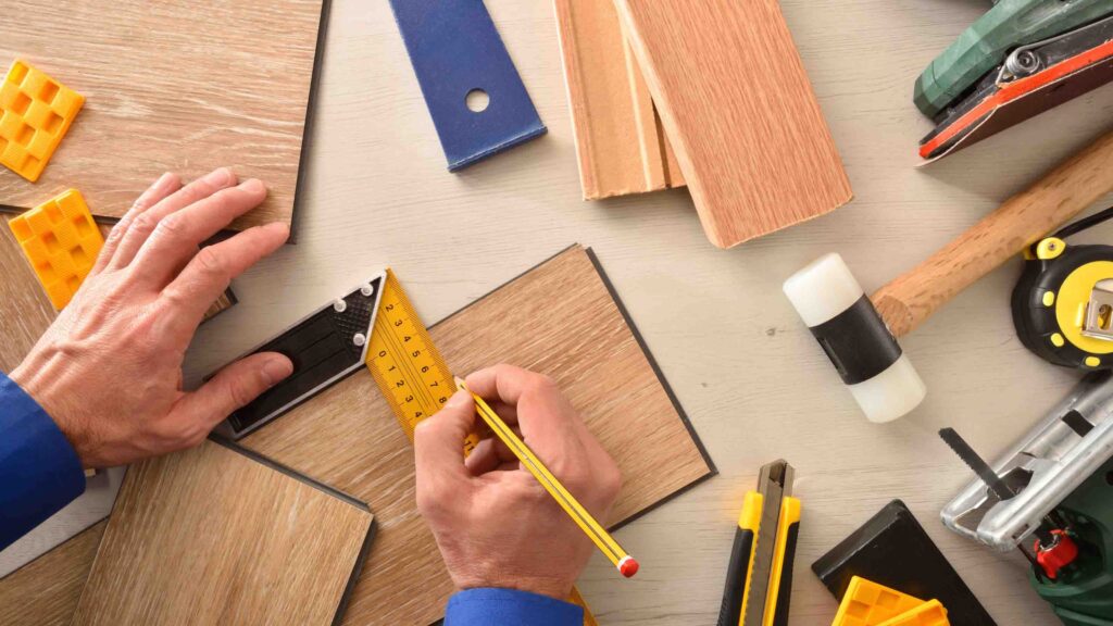 Measuring and marking SPC flooring plank for precise cutting.