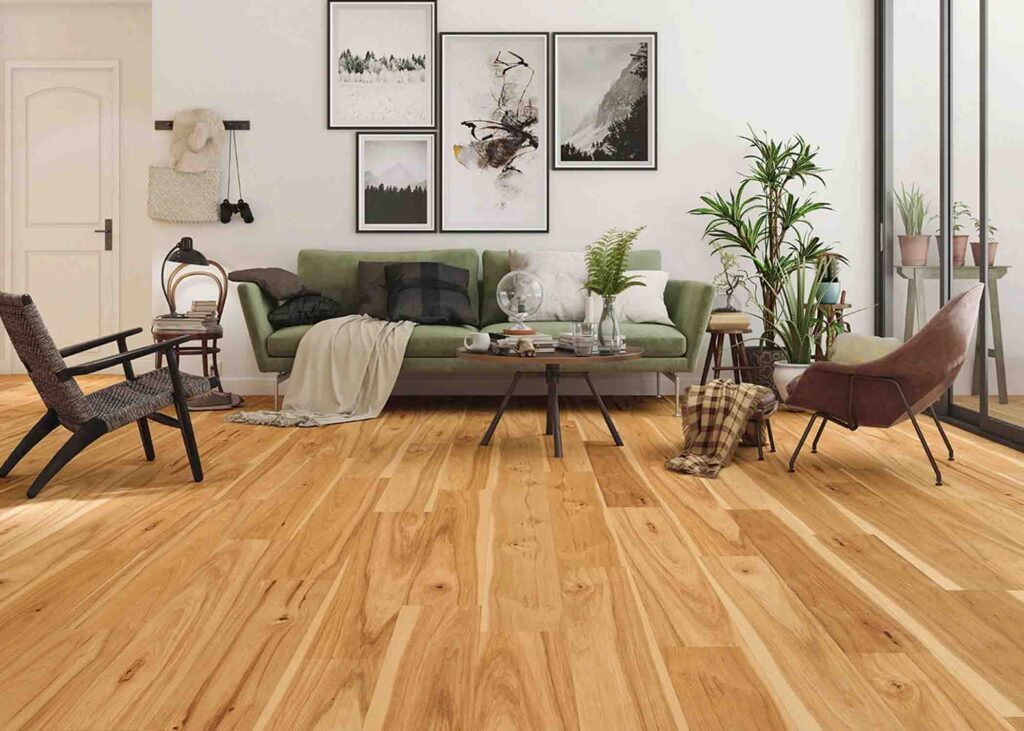 Modern living room with natural wood laminate flooring, green couch, contemporary decor, and large glass windows.